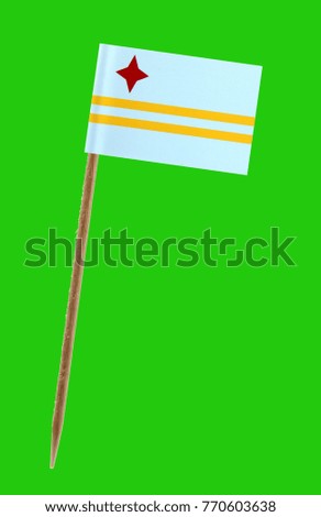 Tooth pick wit a small paper flag of Aruba on a green screen for chromakey