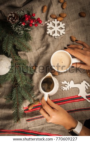 Christmas. A cup. Almond. Biscuit. Coffee. A knife. A folk. A hands