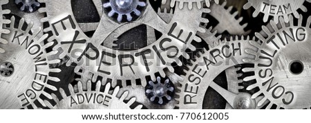 Macro photo of tooth wheel mechanism with EXPERTISE concept related words imprinted on metal surface Royalty-Free Stock Photo #770612005