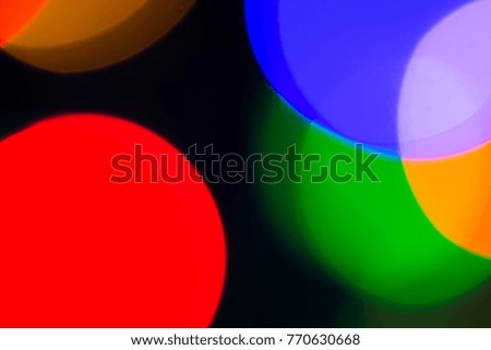 Blurred and defocused abstract multicolor background with christmas lights, soft multicolored bokeh circles.