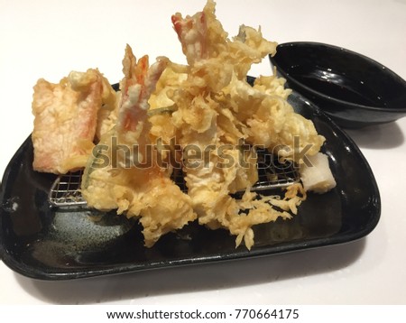Tempura shrimps and vegetables with soy sauce, deep fried shrimps.