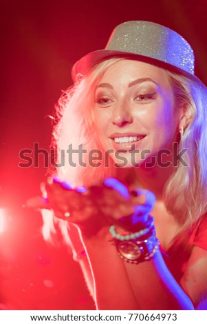 Attractive woman dancing with the laser rays in the Christmas party.