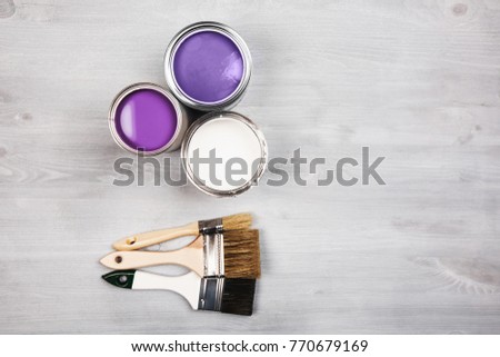 House renovation, paint cans and colored brushes on white wooden background. Ultra Violet color of paint. Royalty-Free Stock Photo #770679169