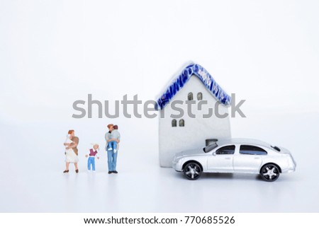 Miniature family with ceramic vintage house and new model car on white background