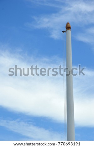 empty flagpole against blue sky