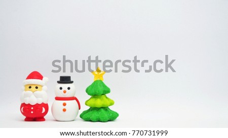 Santa Claus, Snowman, Christmas Tree figurine is on the left side of the picture on a white background, space to insert text.