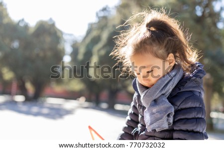 Small Asian girls blowing bubbles in the park, and lovely children play in the sun