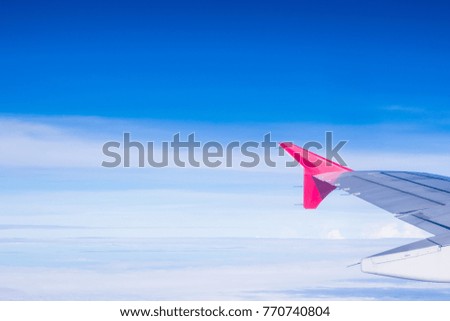 Aircraft Wing of airplane flying on cloud and bluesky background