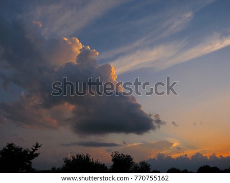 Beautiful big clouds at sunset summer sky
