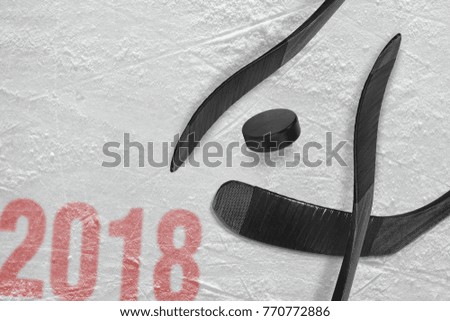 Hockey sticks and washer on the ice of the sports arena. Concept, hockey, season 2018