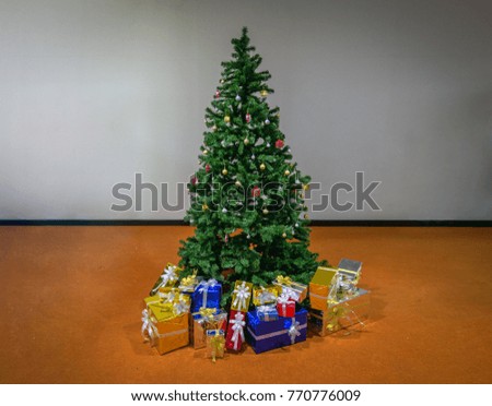 Beautiful holdiay decorated room with Christmas tree with presents under