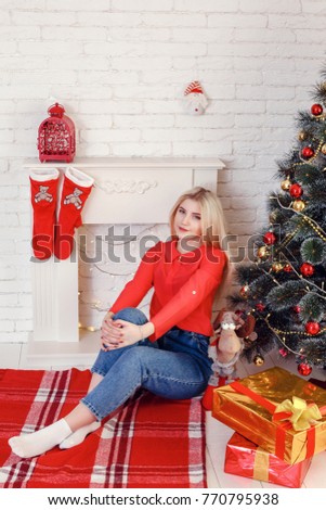 Christmas feeling. After Christmas party. Girls with happy faces near Christmas tree on wooden wall background.