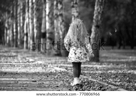 black and white picture of a girl in an autumn park