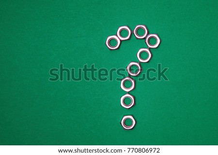 picture of a question mark from the nuts on a green background
