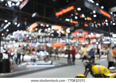 Abstract blurred background image with bokeh light of crowd people at cars exhibition show