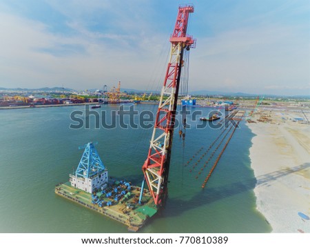 Construction for Marine works this picture for Construction Bert and Jetty, Construction Steel Pipe Pile used Piling Barge for driven pile and construction site workers. - aerial - Top View