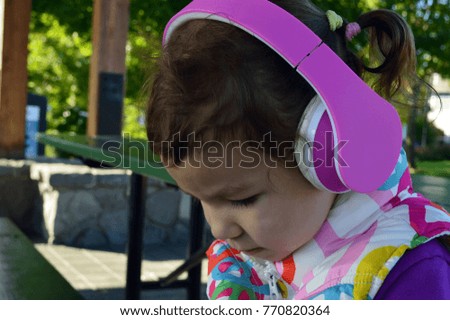 little girl with headphones 