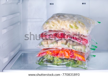 Frozen vegetables in bags in refrigerator