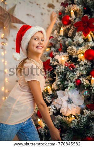 Photo of girl in Santa caps on background of New Year's decorations