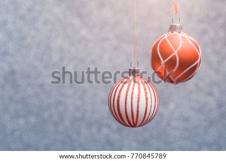 Image of Christmas red balls with patterned gray blurred background.