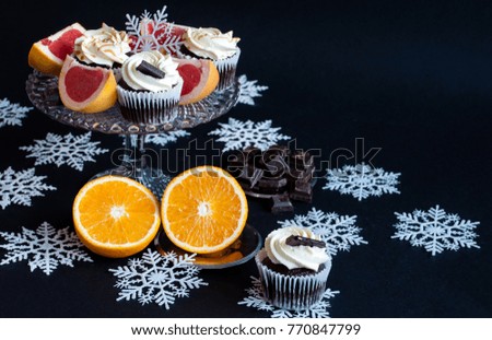 tasty cupcakes on a dark background. Christmas, chokolate colorful cupcakes with snowflake. Christmas and New Year background. 