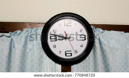 One clock have time 20.47 AM hang to the wall