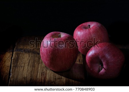 A picture of a painting apple with a dark background