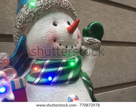 This is a sculpture of snowman in the street for Christmas. He is so cute and nice with a scarf, a hat and gloves. 