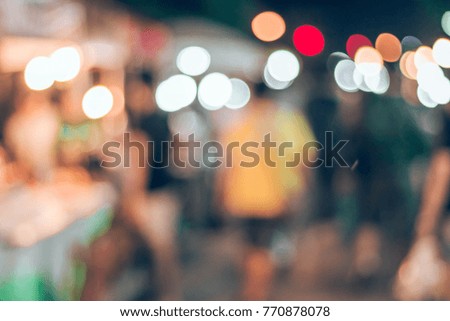 Blurred images of people walking in the market.