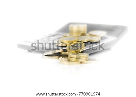 Pound Coins with Calculator - Close-up on White Faded Background Royalty-Free Stock Photo #770901574