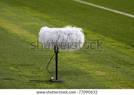 Directional microphone boom with windshield at a football stadium