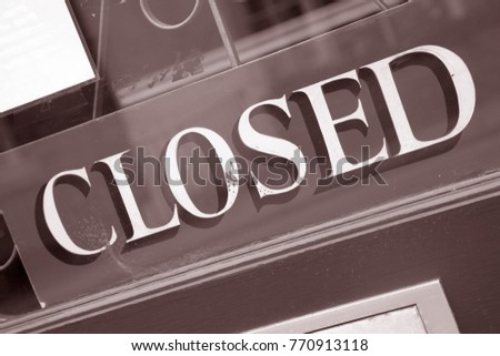 Closed Sign on Door Window in Black and White Sepia Tone