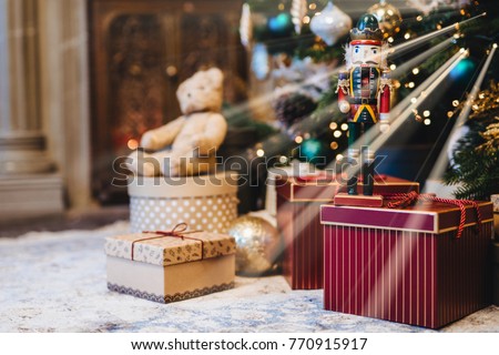 Picture of decorated Christmas or New Year tree with many gifts against home interior. Handmade present and many boxes under fir tree. Seasonal holidays. Winter, holidays concept