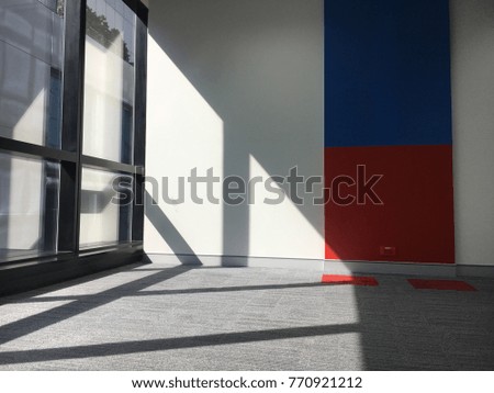 Shadow of the light on the floor and the colour wall.