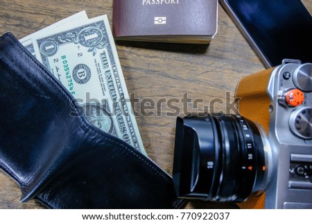Money camera passport Behind wooden floor Holiday travel