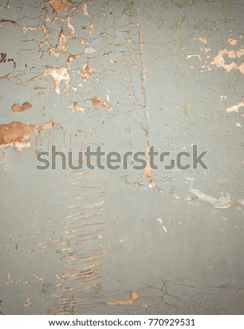 blue faded surface with peeling paint and sand