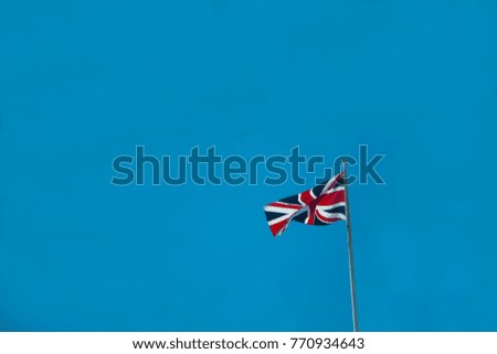 UK flag with a blue sky background