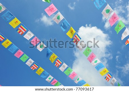 Strings Of Celebration Flags Against Blue Sky