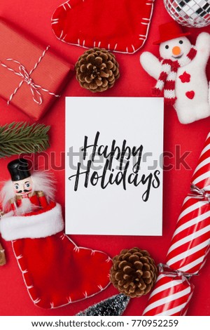 Festive message on white paper with a collection of Christmas decorations. 