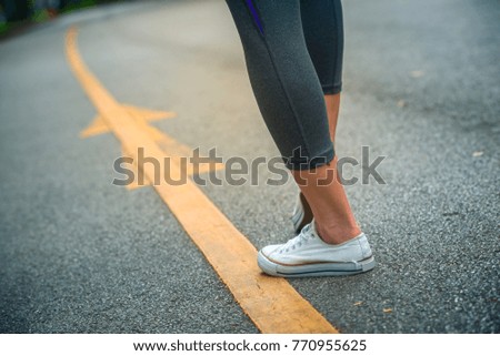 Active woman ready to follow the arrow for running. Success concept and way of life