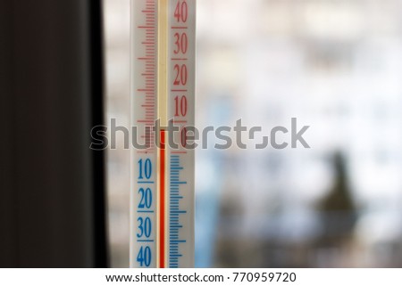 The thermometer outside the window closeup