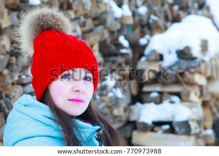 Beautiful woman in a knitted hat for a winter walk
