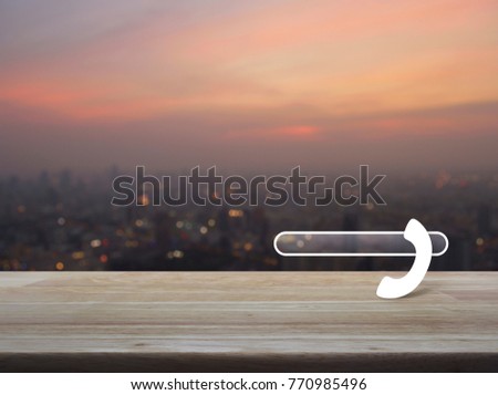 Phone icon with copy space for add your phone number on wooden table over blur of cityscape on warm light sundown, Contact us concept