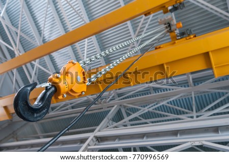 Factory overhead crane hook and chain Royalty-Free Stock Photo #770996569