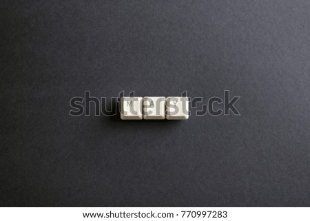 May month word is written with computer keys button. Flat lay view from above on the table with computer keyboard keys buttons on a dark background.