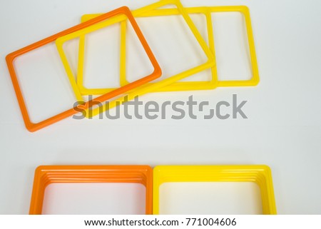 yellow and orange plastic frames for price tags. Equipment for shops