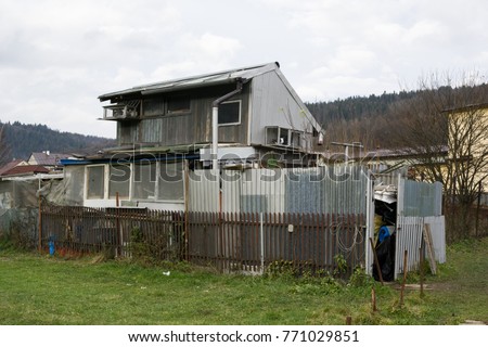 Ugly shack and shanty made of cheap materials. Rustic building with corrugated iron. Authentic hovel in the poor ghetto and slum Royalty-Free Stock Photo #771029851