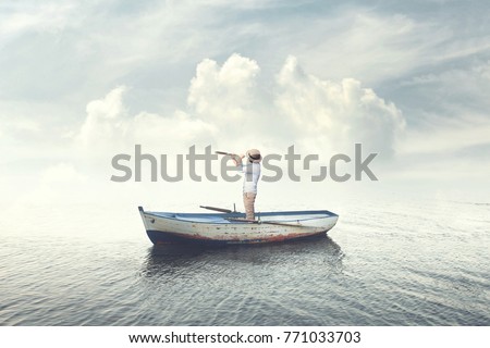 business man on a boat watching the future with binoculars Royalty-Free Stock Photo #771033703