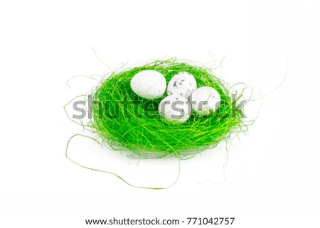 isolated white chicken egs on green grus on white background