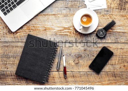 Working place with notebook on wooden table